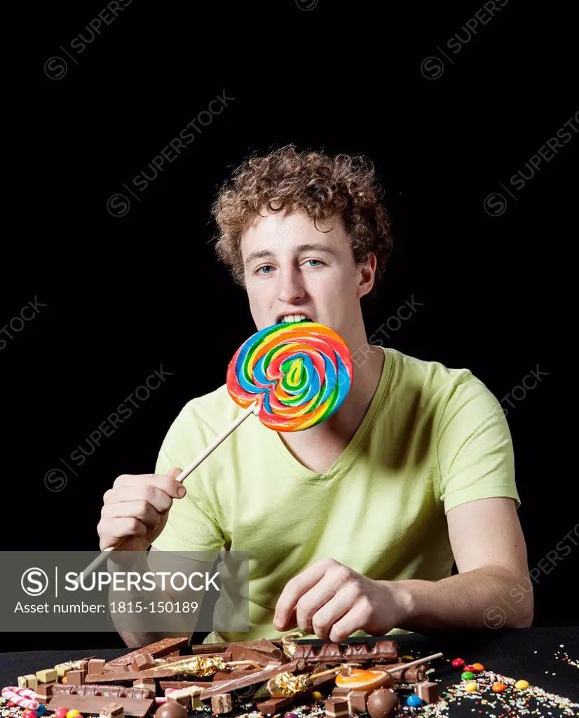 Young man with lollipop and sweets