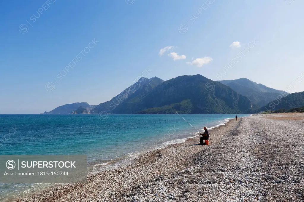 Turkey, Lycia, Man fishing on beach of Olympos