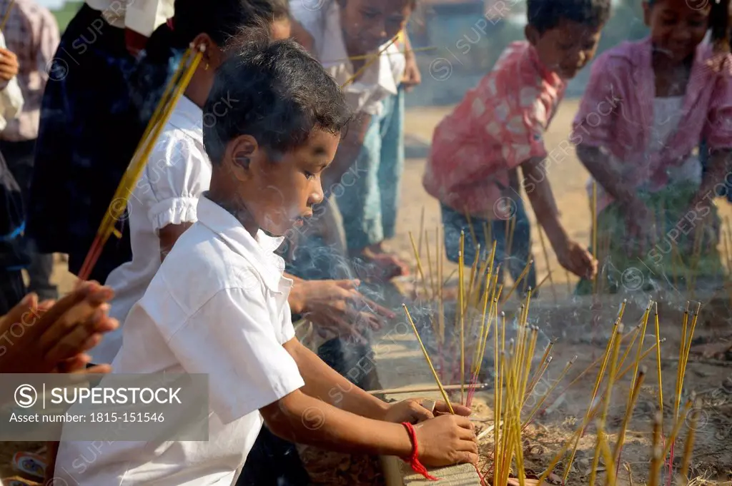 Cambodia, Takeo Province, Lompong, Children with joss sticks preparing New Year's festival