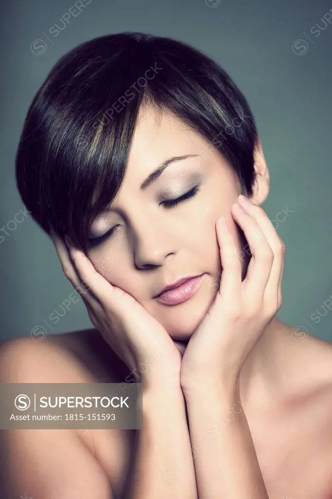 Portrait of young woman with closed eyes, studio shot