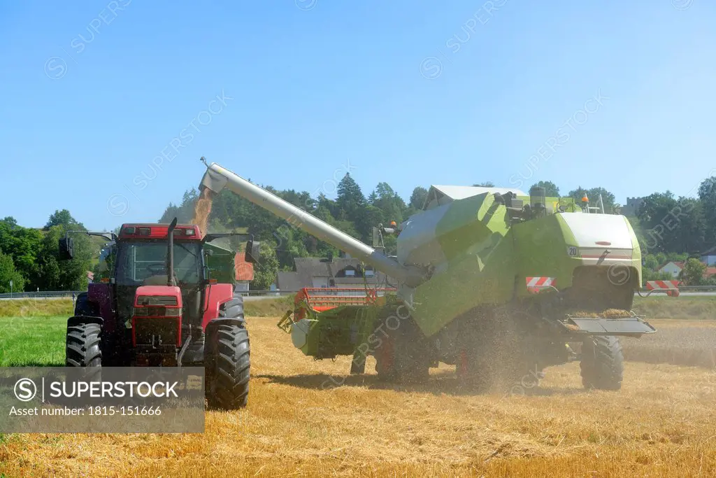 Germany, Upper Bavaria, Combine harvester in field of wheat