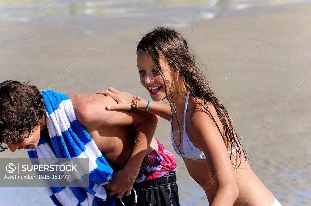 Holland, Zeeland, Domburg, boy and girl having fun on the beach