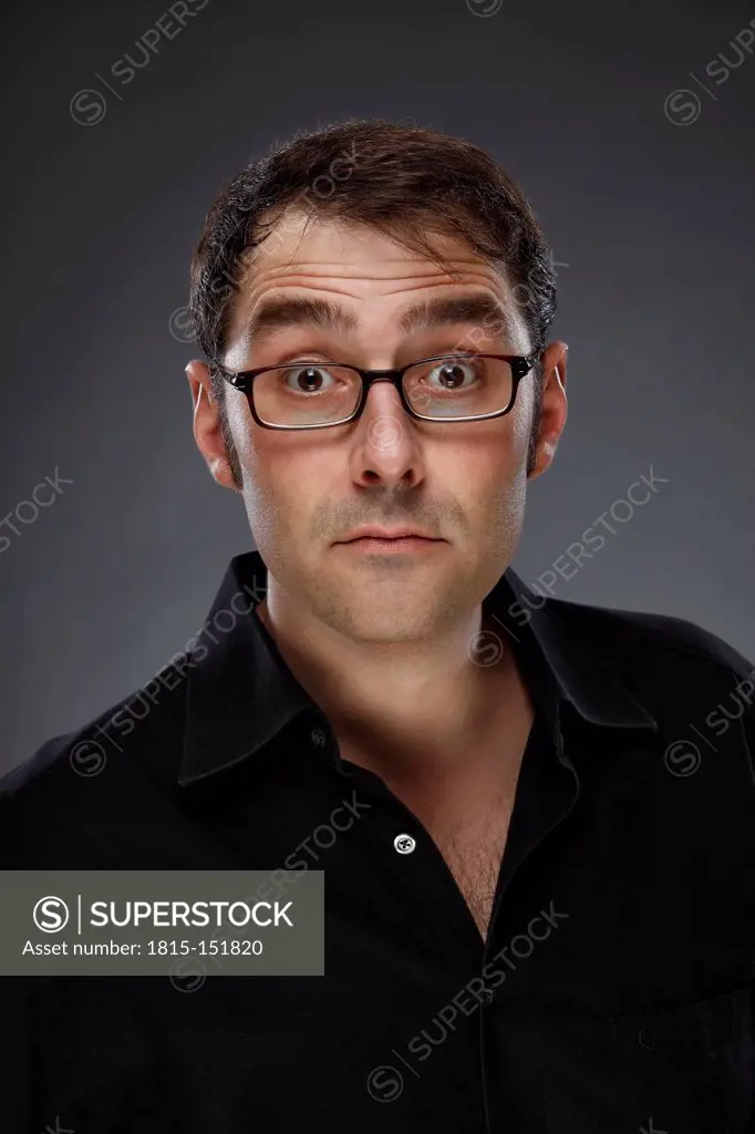 Portrait of sceptical man wearing glasses, studio shot