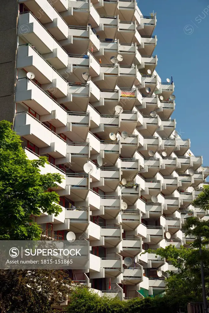 Germany, North Rhine Westphalia, Cologne Chorweiler, High-rise apartment building with balconies and satellite dishes