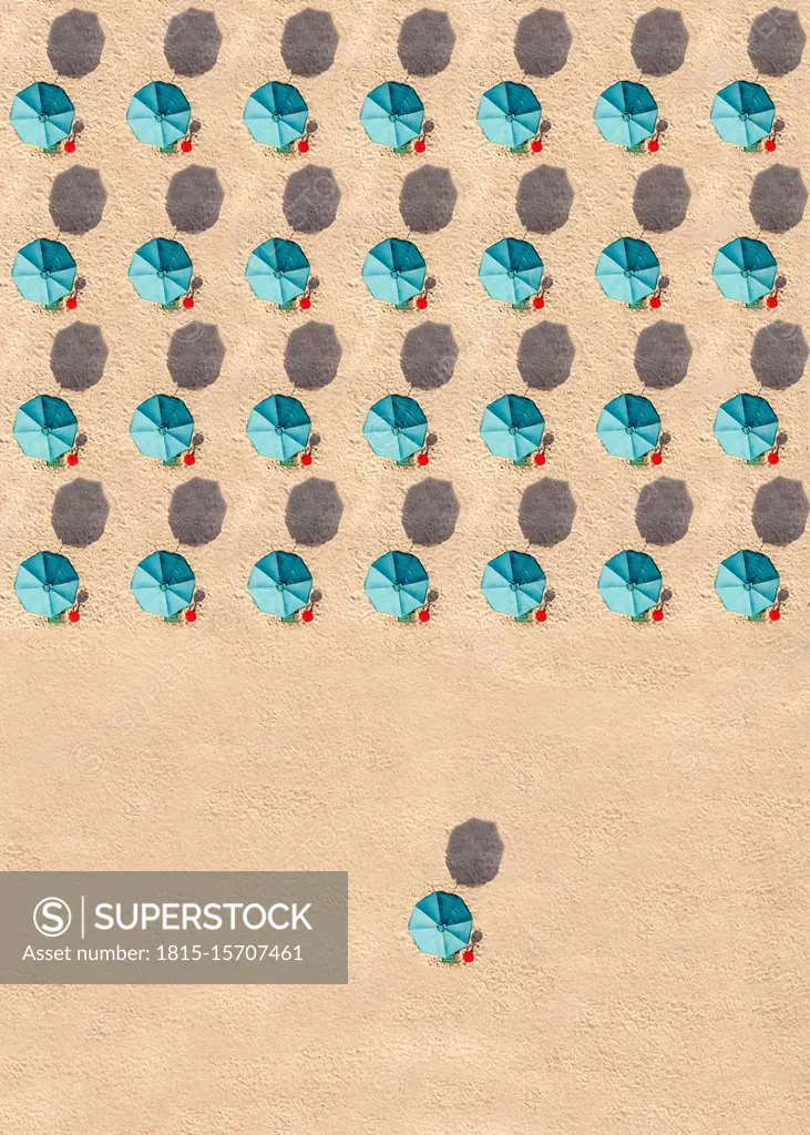 Aerial view of rows of turquoise colored beach umbrellas