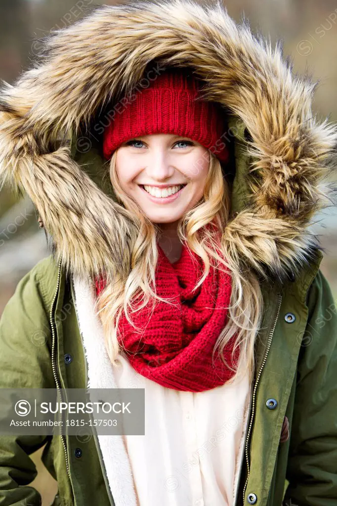Portrait of young woman wearing woolly hat and hooded jacket