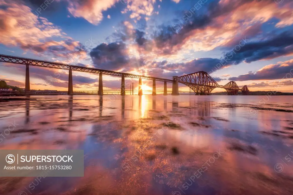 UK, Scotland, South Queensferry, Forth Bridge at dramatic sunset
