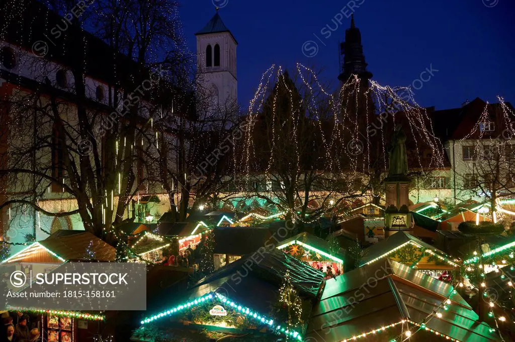 Germany, Baden-Wuerttemberg, Freiburg, lightened Christmas market at town hall square at twilight