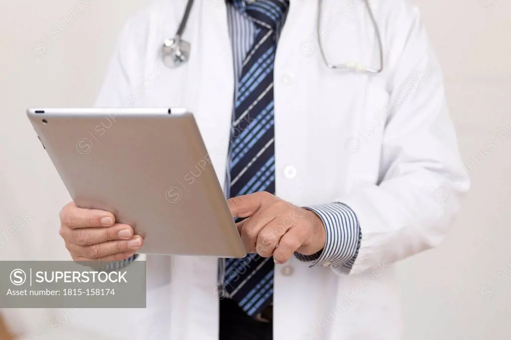 Germany, Doctor using digital tablet