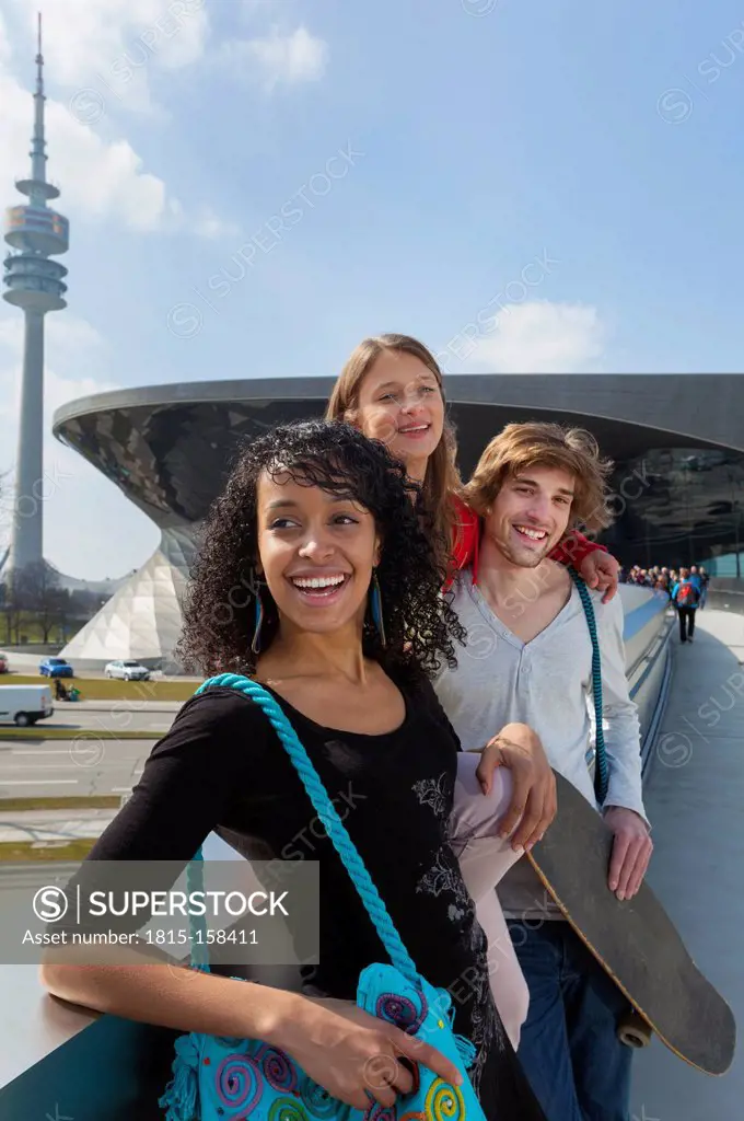 Germany, Bavaria, Munich, Three friends having fun at the Olympic Park
