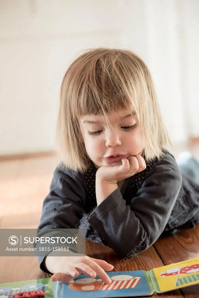 Little girl looking at picture book