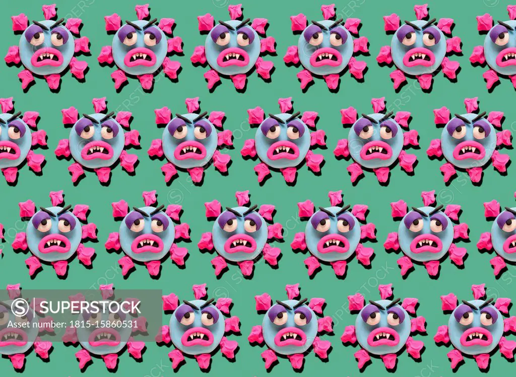 Rows of coronoa viruses with plasticine faces on green background
