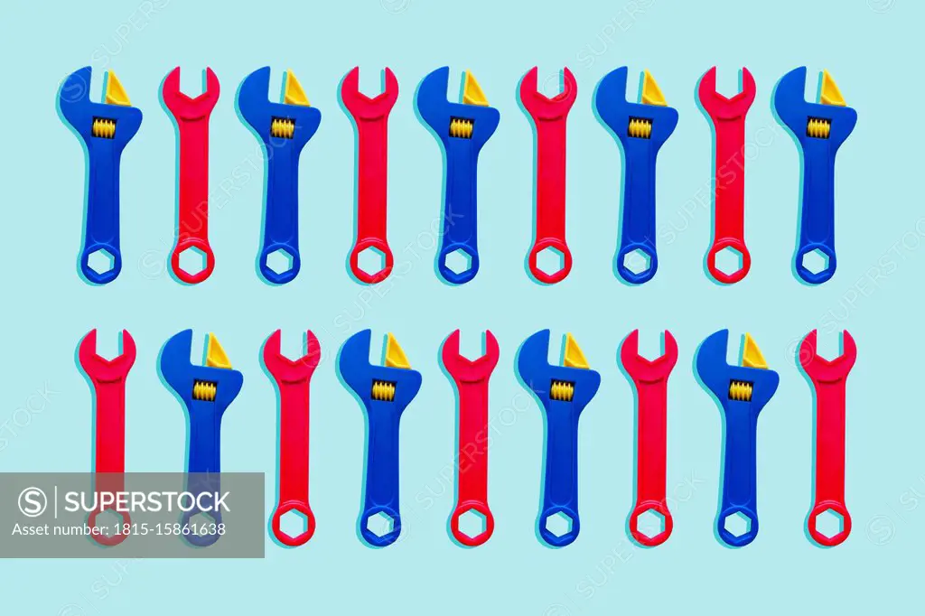 Illustration of two rows of red and blue toy wrenches