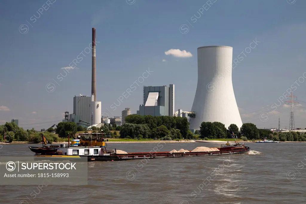 Germany, North Rhine-Westphalia, Ship on River Rhine and Duisburg Walsum power plant