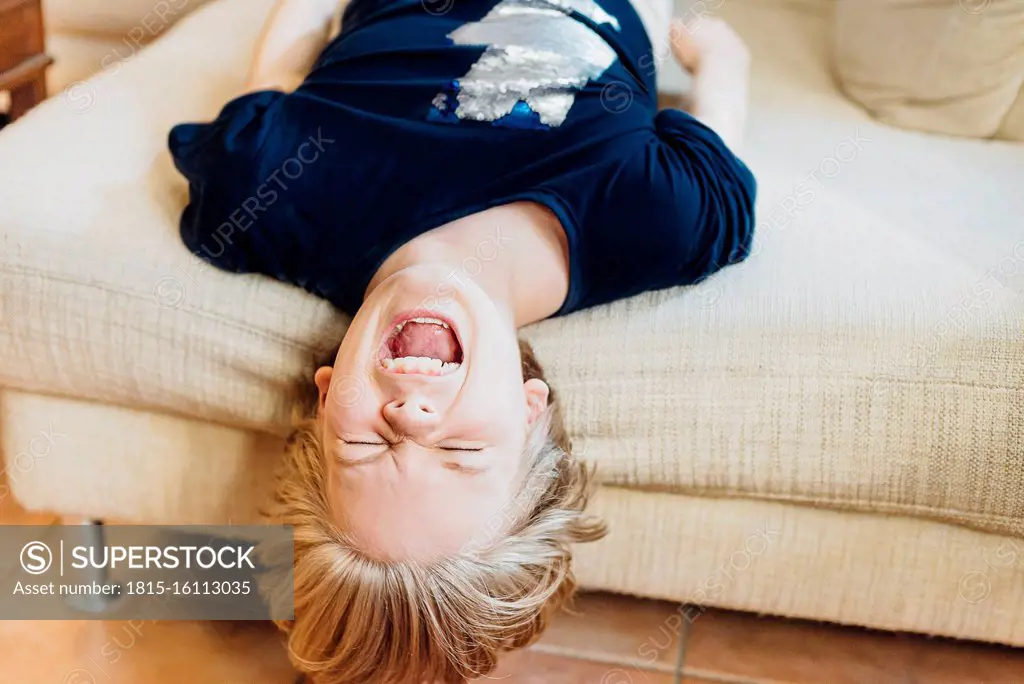 Screaming boy lying on couch
