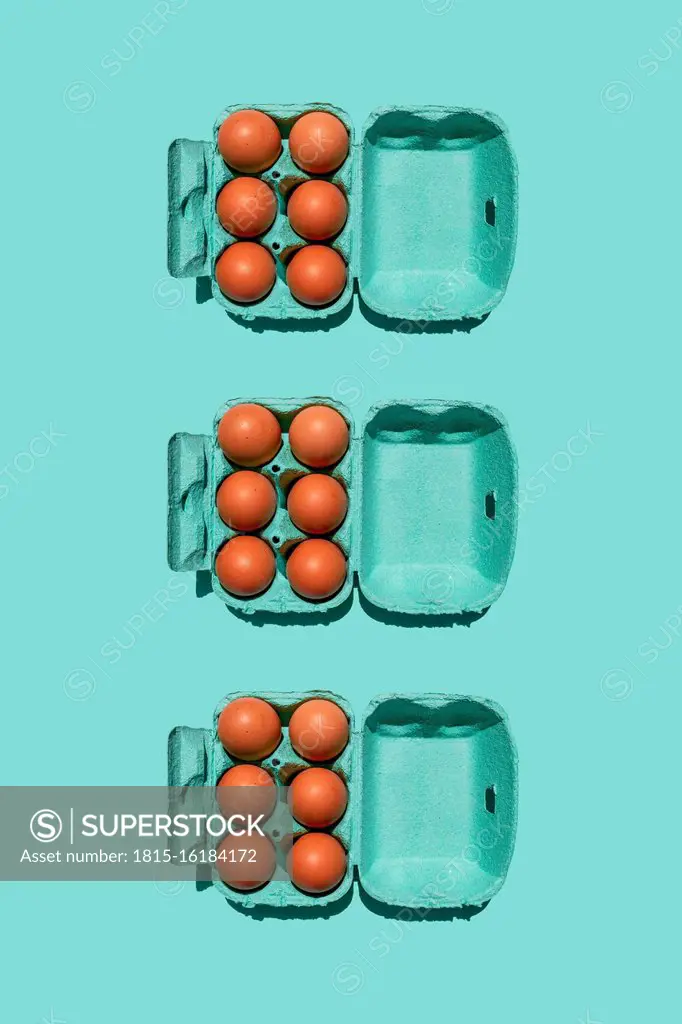 Studio shot of chicken eggs in turquoise colored cartons