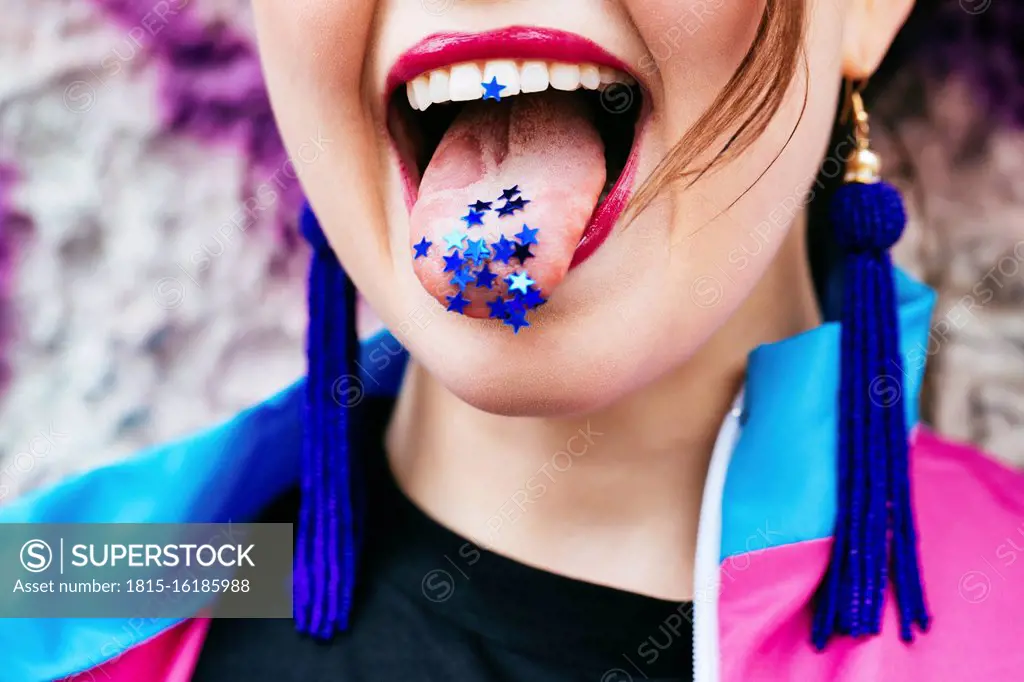 1980s retro-styled woman with stars on tongue