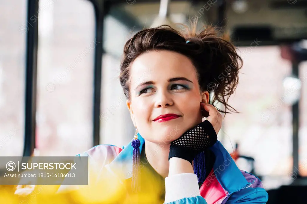 1980s retro-styled woman sitting in an old bus