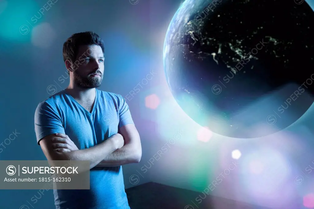 Serious looking man watching earth