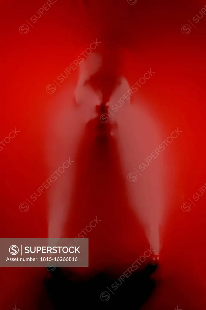 Three dimensional render of human face wrapped in red plastic foil