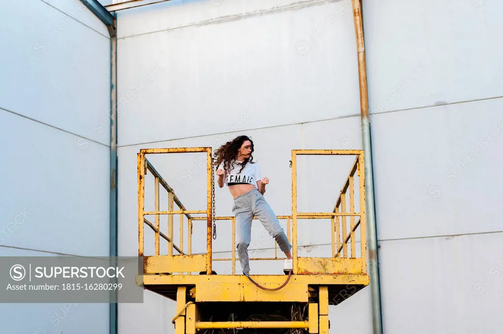 Female hip-hop dancer dancing on metallic platform in abandoned building