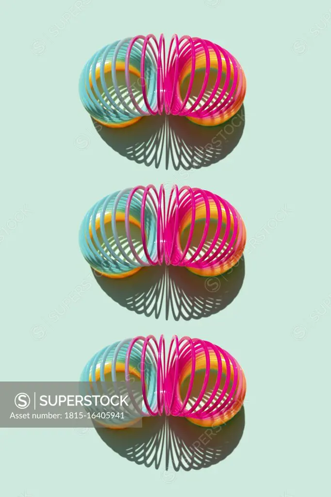 Studio shot of three plastic Slinky springs