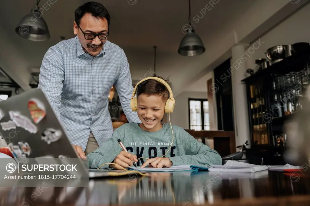Fatherc helping son with his homework