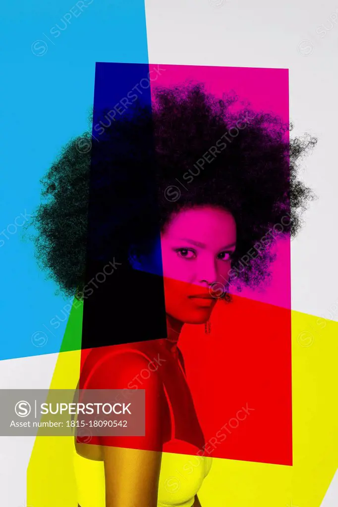 Confident woman with primary colors against white background