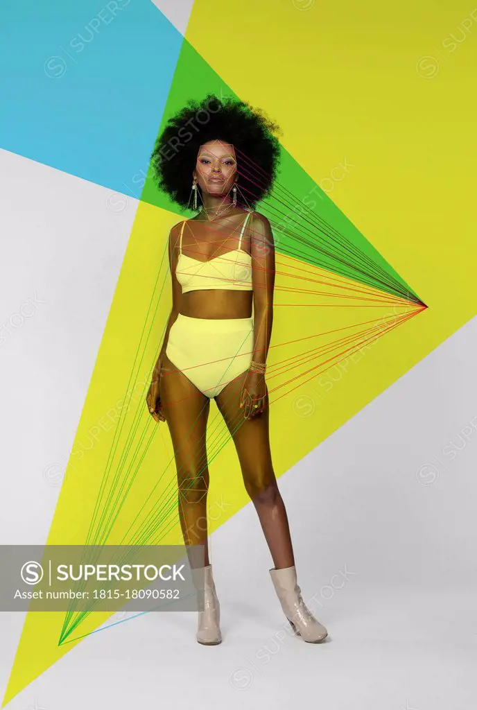 Afro woman with facial recognition laser beams standing against white background