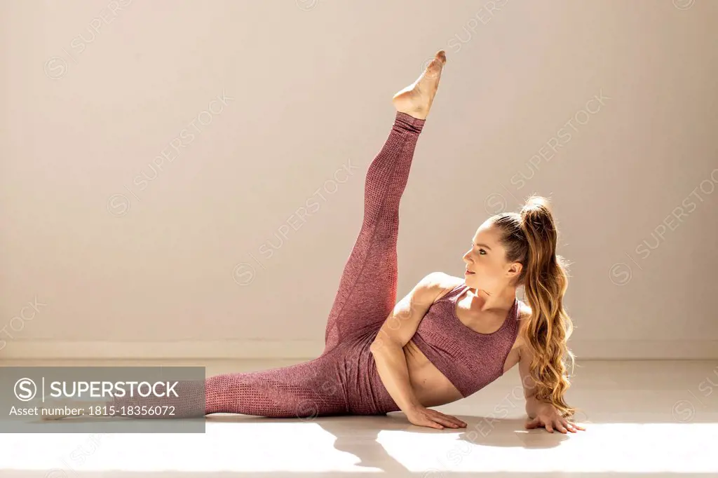 Flexible woman practicing leg exercise