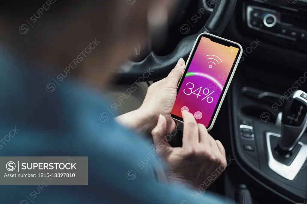 Woman connecting mobile phone with wifi in car