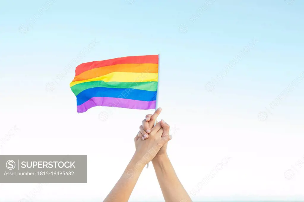 Lesbian couple holding rainbow flag