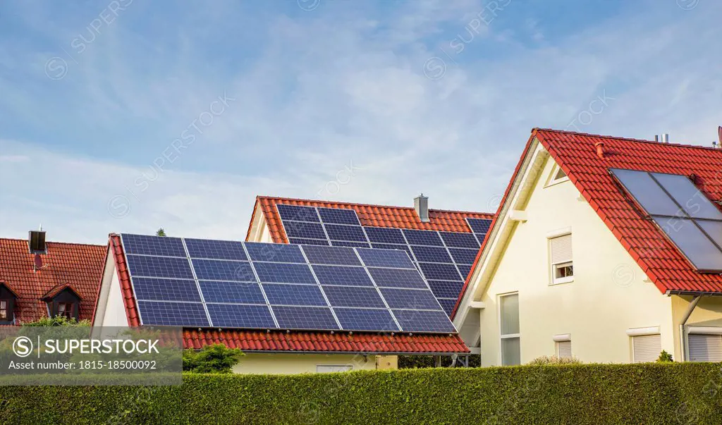 Suburb houses with tiled roofs and solar panels