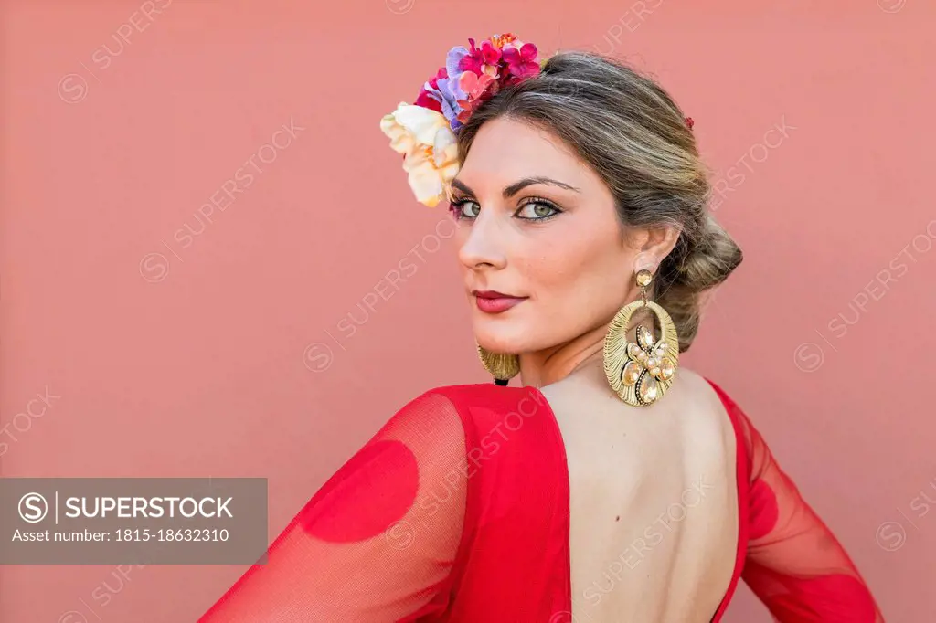 Young dancer wearing flowers with traditional flamenco dress