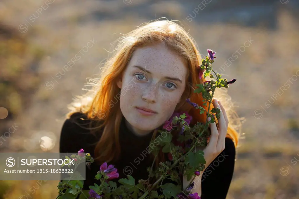 Redhead woman with flowering plant
