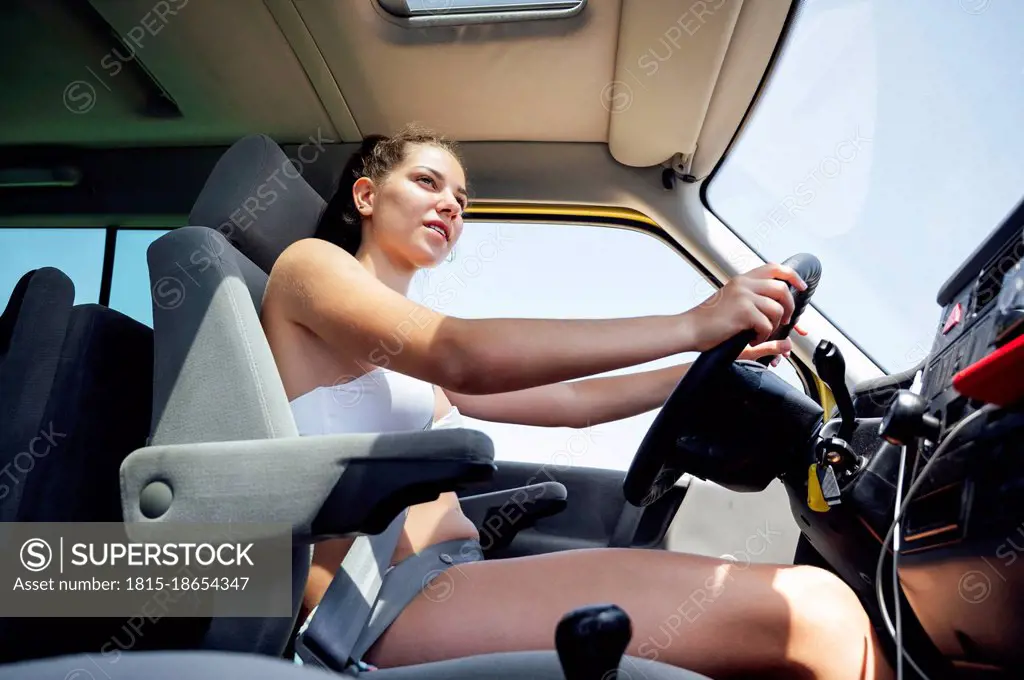 Mid adult woman driving camper van