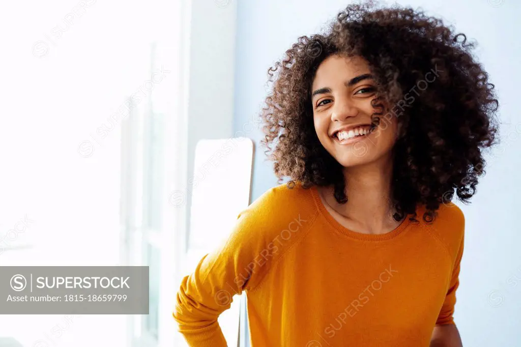 Happy Afro woman at home