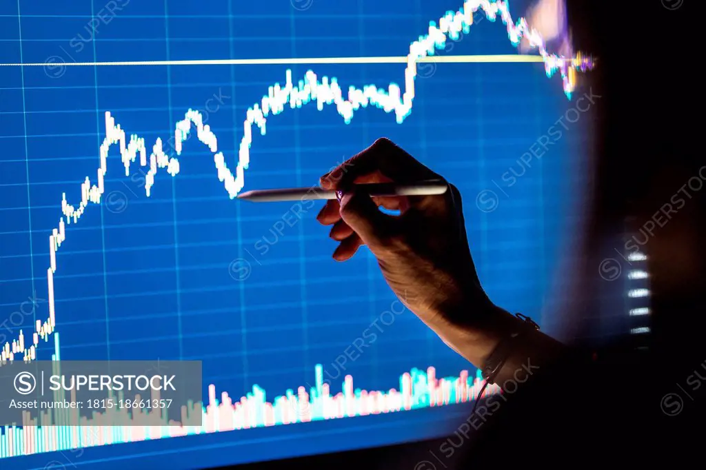 Female business professional checking stock market graph on screen