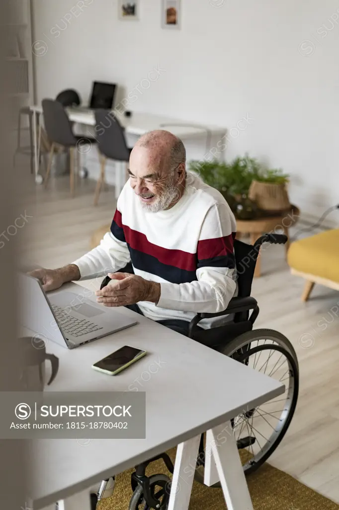 Smiling businessman with physical disability working at home