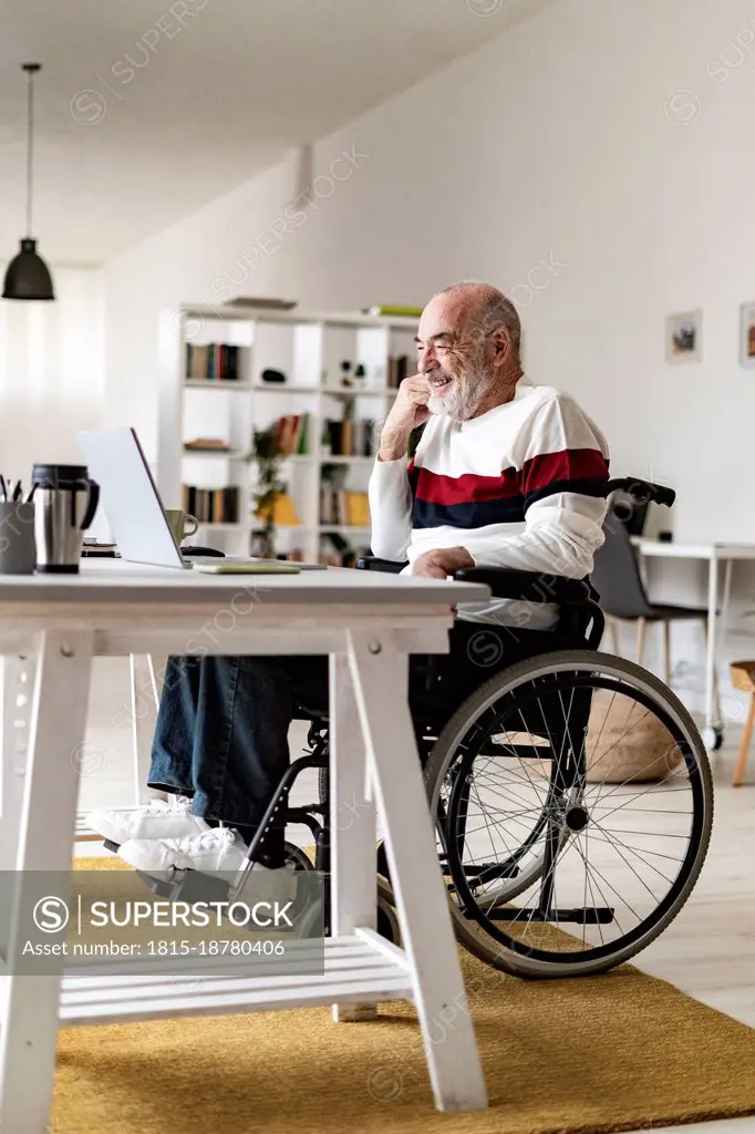 Disabled businessman attending video call through laptop at home