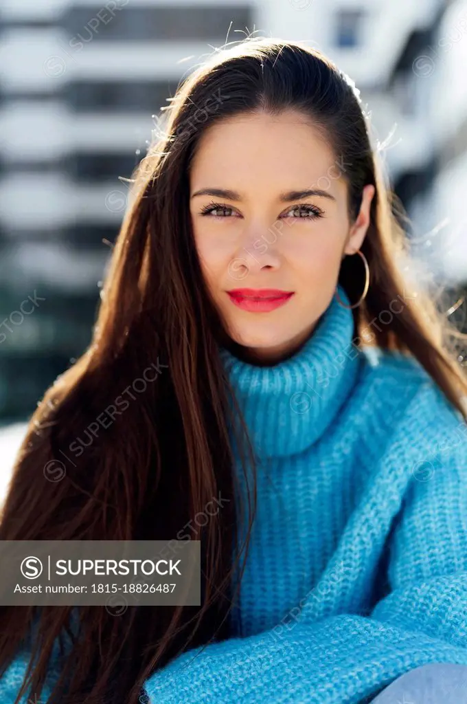 Confident woman wearing blue turtleneck sweater