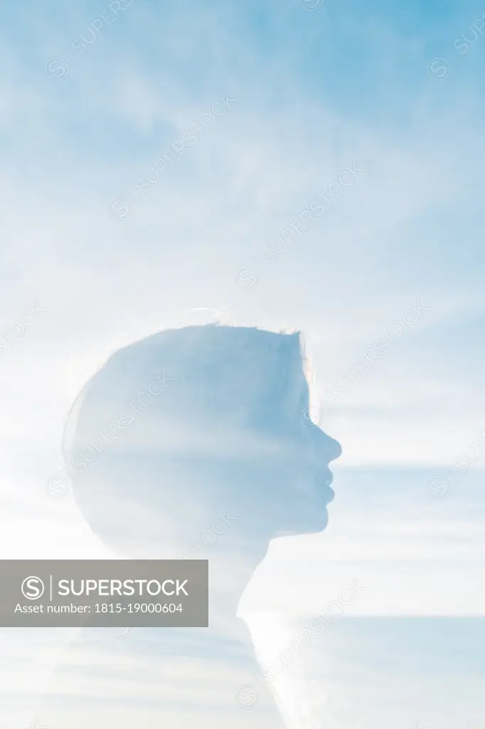 Double exposure of woman with sky