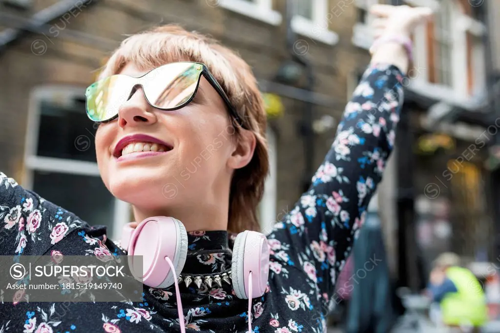 Carefree young woman wearing sunglasses