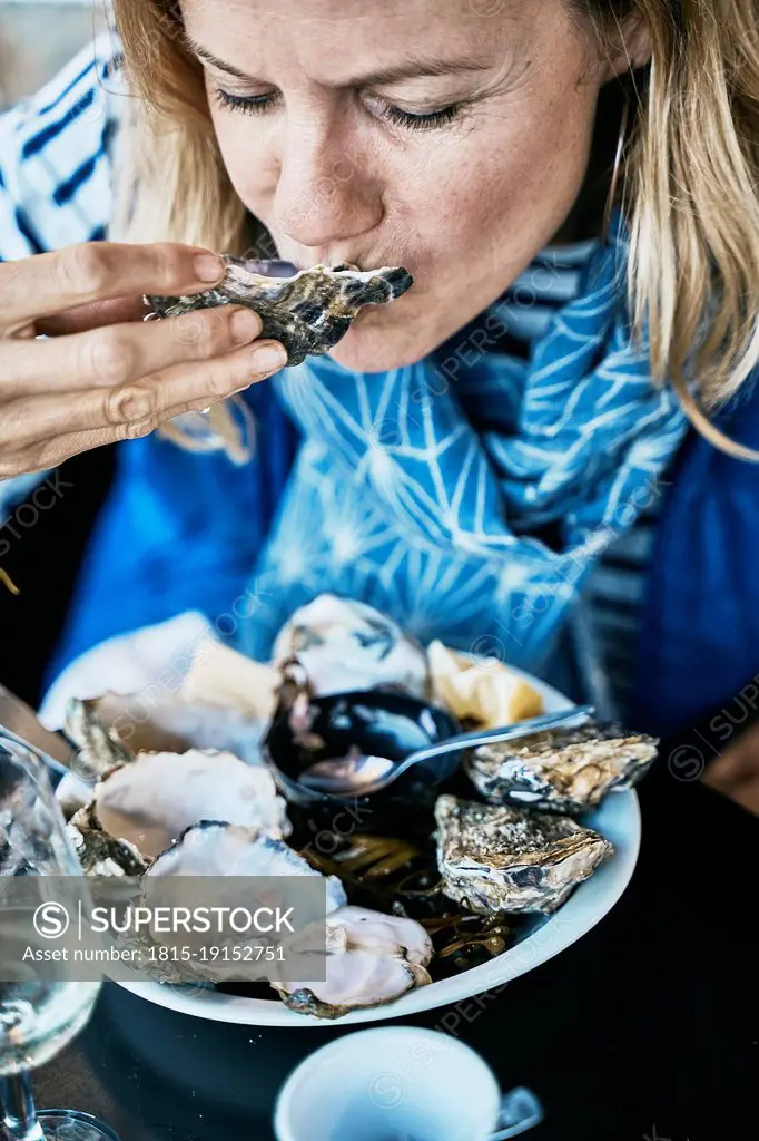 Tourist eating oysters at vacations