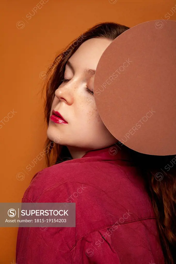 Beautiful woman posing with circle in studio
