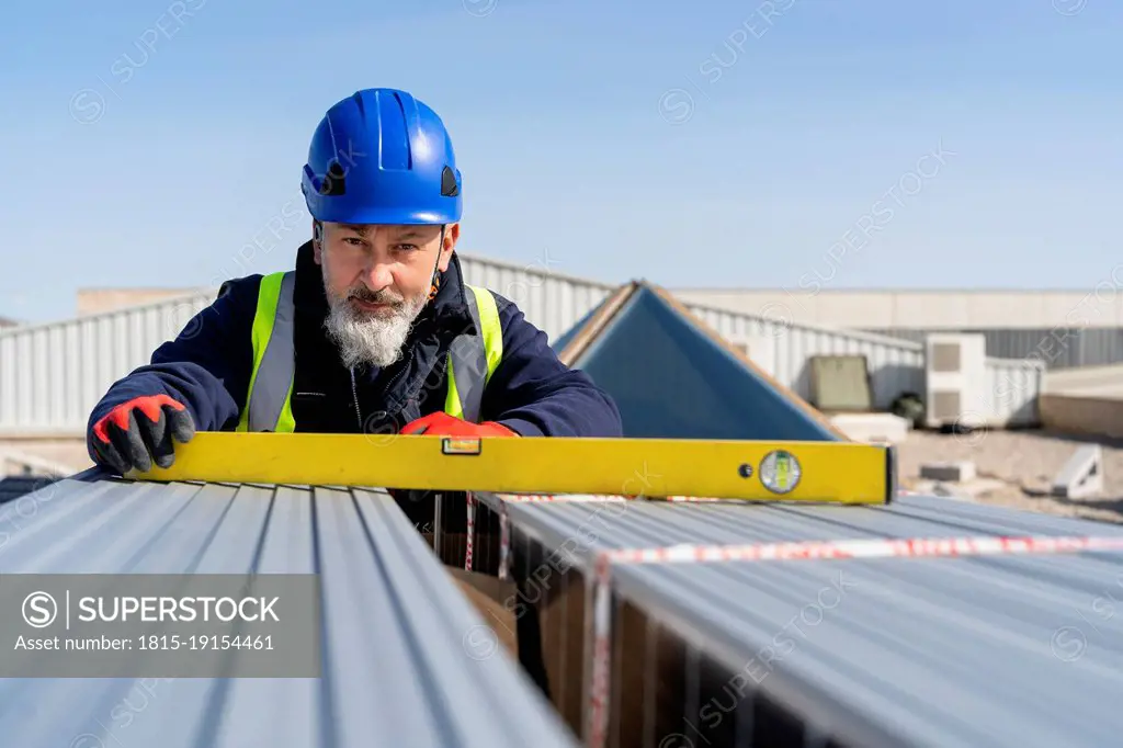 Engineer with measurement tool working at solar power station