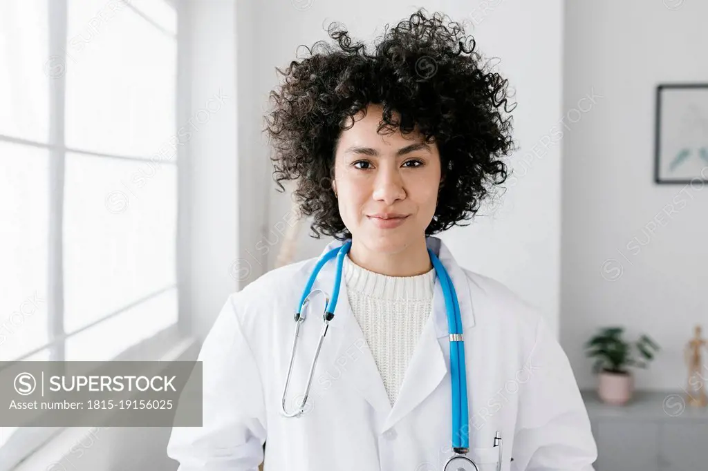 Doctor with curly hair at medical clinic