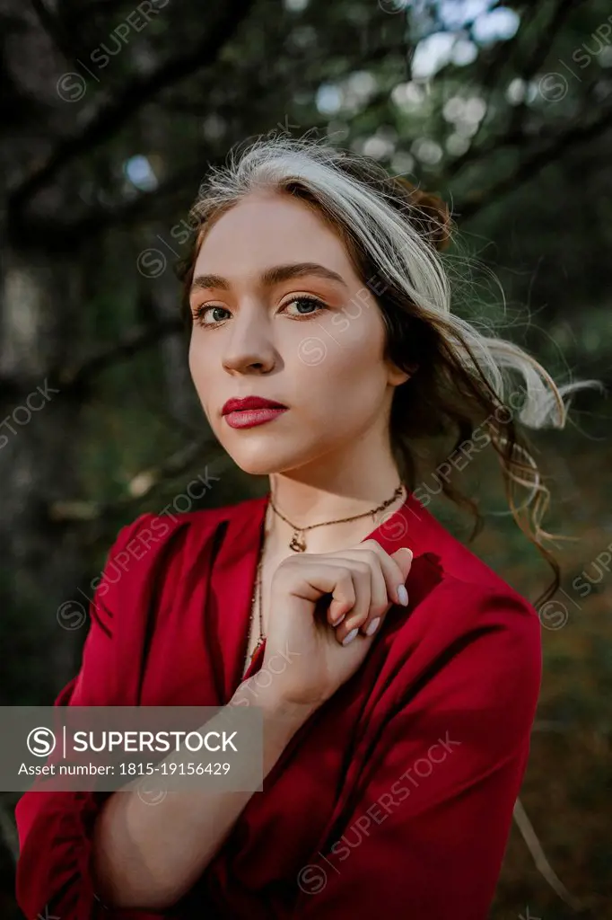 Beautiful woman in red dress in nature
