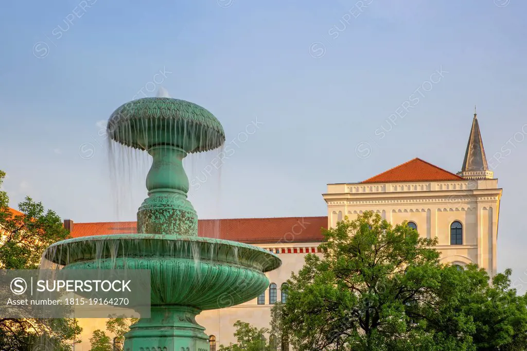 Germany, Bavaria, Munich, Schalenbrunnen fountain with Ducal Georgianum university in background