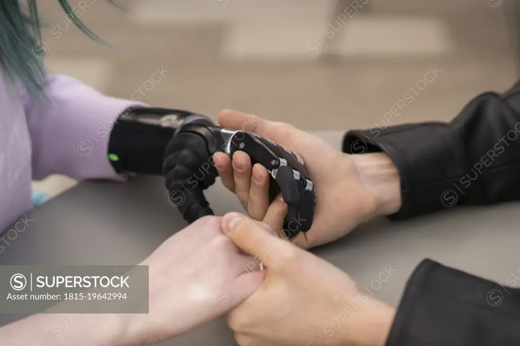 Young couple holding hands on table